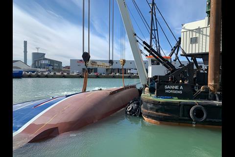 On its side in port the vessel is ready for righting (J.A.Rederiet)